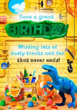 Yellow Happy Birthday greeting card 2021 (with editable text and animation) toy dinosaur and colorful candies on the table in the flamboyant playroom - Picture
